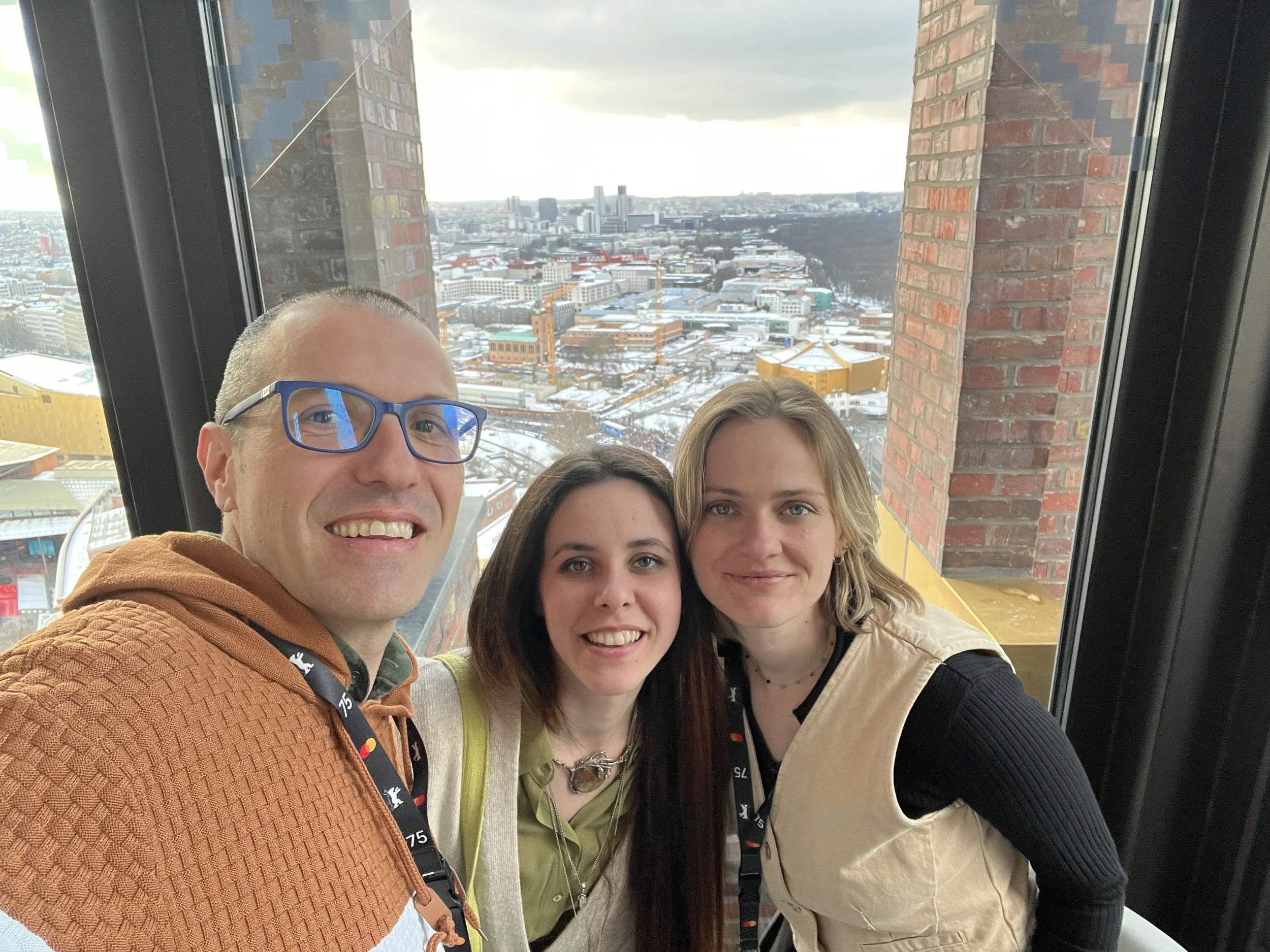 Aurora Ovan, Yulia Protasova, and Gerard Pastor in a selfie in Berlin, with the Philharmonie in the background